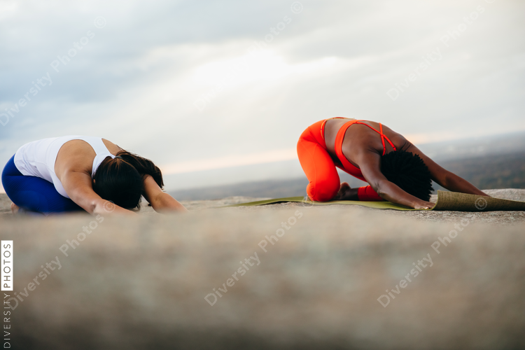 Black woman doing yoga at park