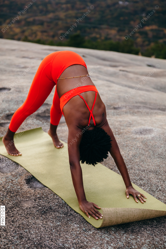 Black woman doing yoga at park