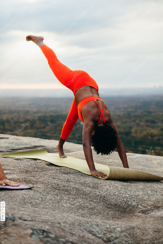 Black woman doing yoga at park
