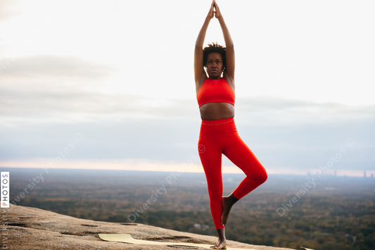 Black woman doing yoga at park