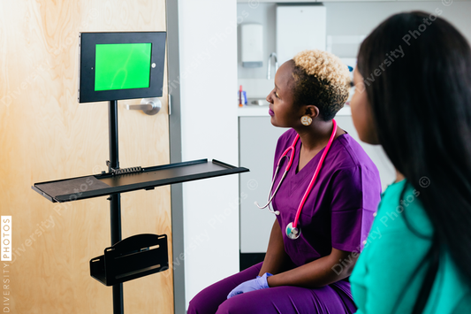 Black nurse and patient talks to virtual translator on video screen chat