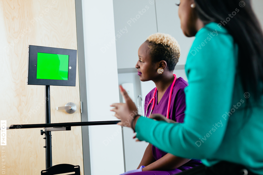 Black nurse and patient talks to virtual translator on video screen chat