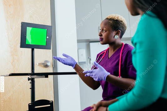 Black nurse and patient consults with virtual tele-health doctor on video chat screen