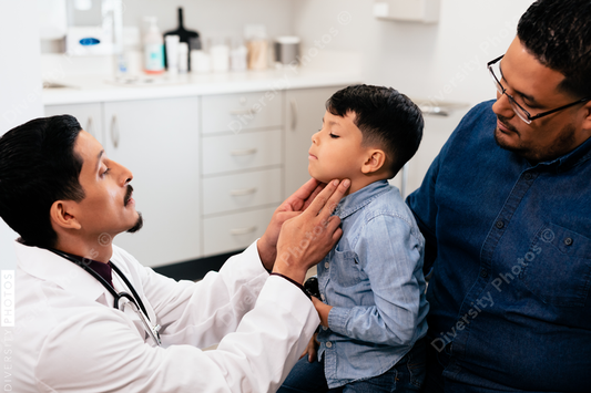 Young latino toddler with father and doctor for a physical exam and wellness visit