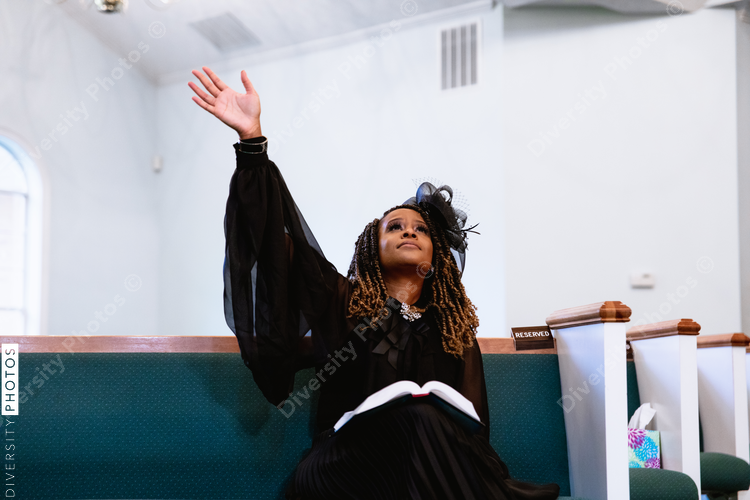 Black woman giving praise and worship to heavenly Father