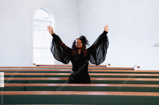 Black woman giving praise and worship to heavenly Father on Easter Sunday