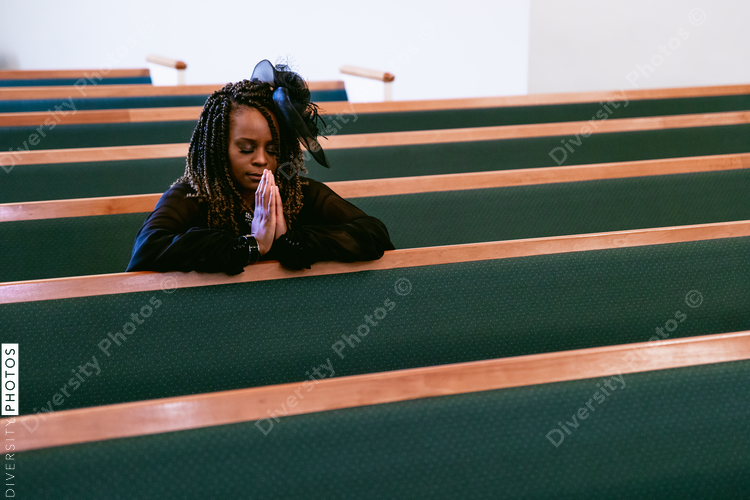 Woman praying to God in Kingdom church home