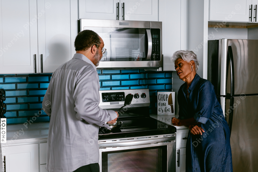African American husband wife senior couple having conversations in kitchen