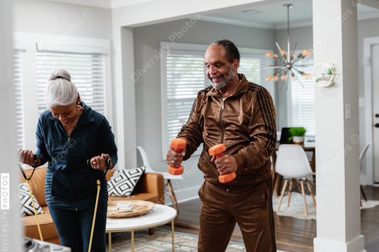 African American senior couple exercises together at home