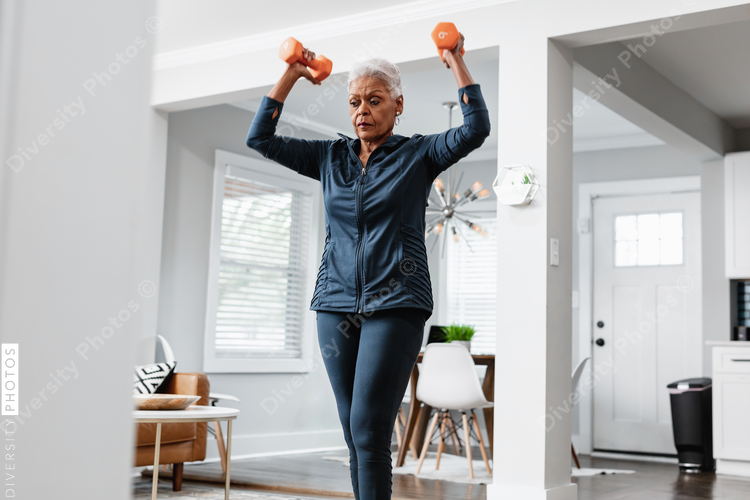 Senior Black woman exercising at home, active lifestyle fitness