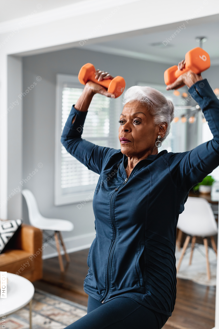 Senior Black woman exercising at home, active lifestyle fitness