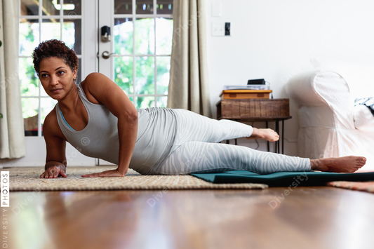 African American woman doing palates core strength training at home