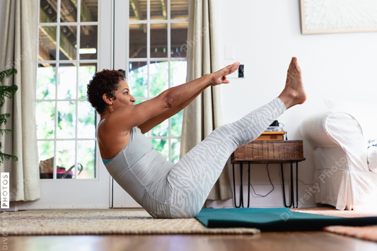 African American woman doing palates core strength training at home