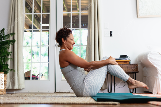 African American woman doing palates core strength training at home