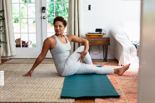 African American woman doing palates core strength training at home