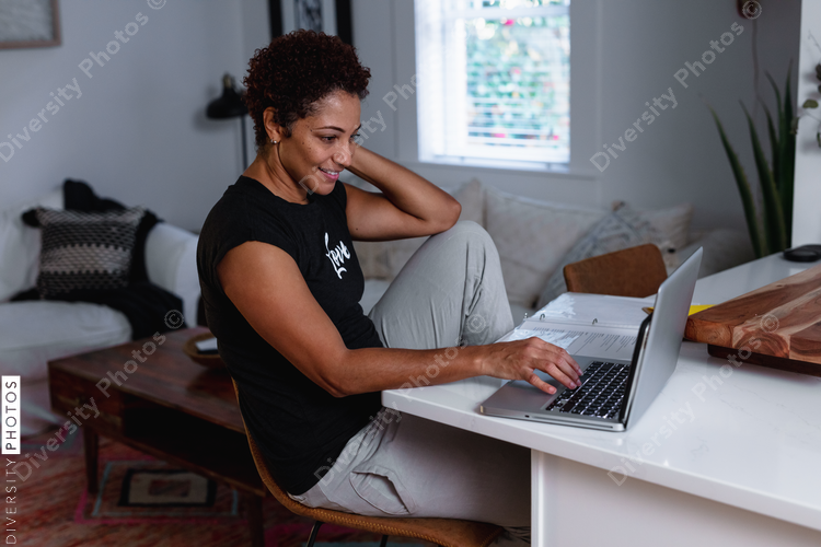Creative woman works from home remotely using laptop