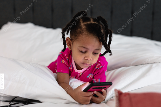 Young girl playing games on parent phone