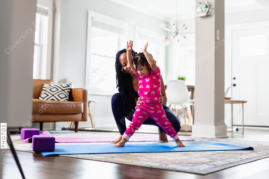Black mother helps daughter exercise at home