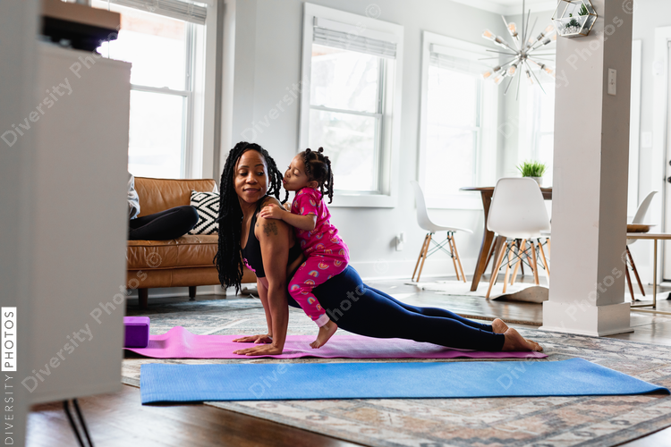 Mother and daughter working out at home doing exercises