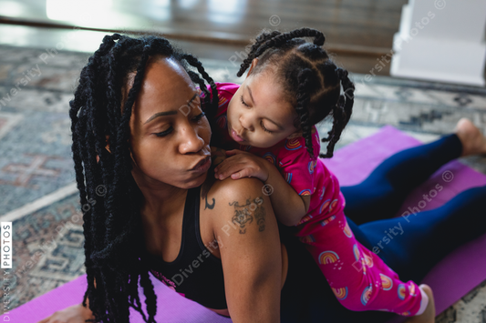 Black mother and daughter blowing loving kiss