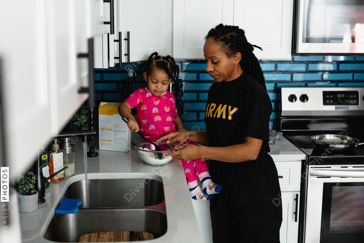 Military mother prepares breakfast with daughter