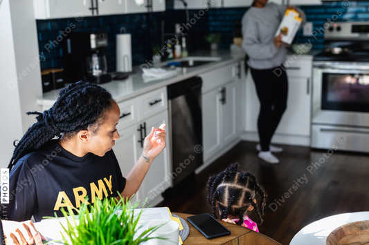 Black family preparing breakfast in kitchen