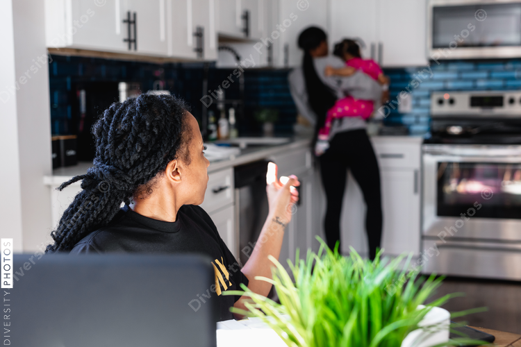 Black family preparing breakfast in kitchen