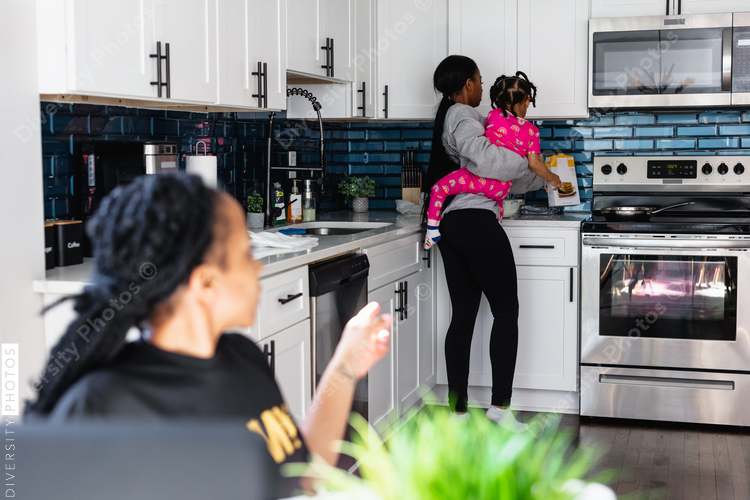 Black family preparing breakfast in kitchen
