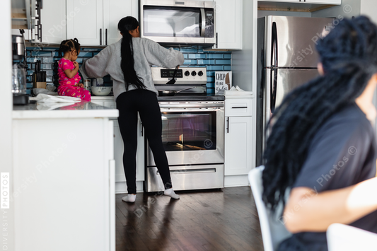 Black family preparing breakfast in kitchen