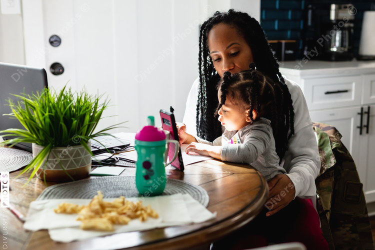 Woman working from home with child toddler