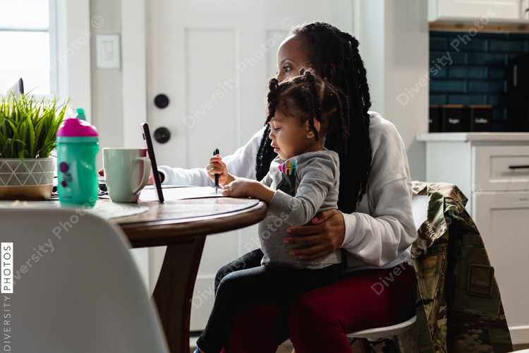 Woman working from home with child toddler