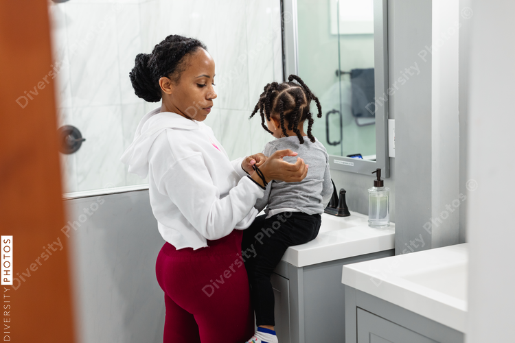 Mother and daughter getting ready in the morning in bathroom