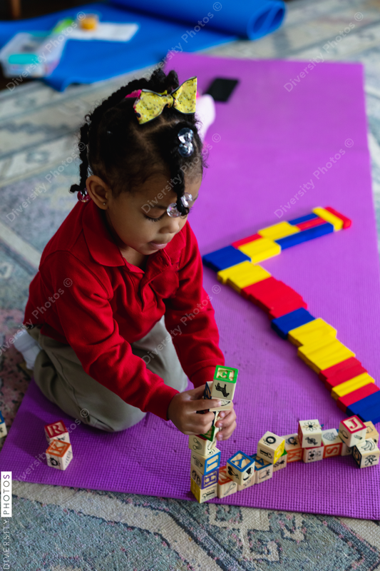 Young black girl playing with blocks