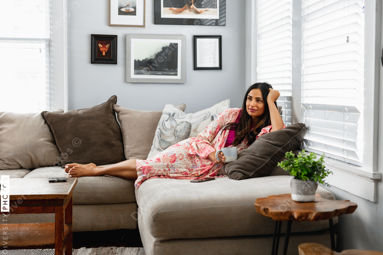 Indian woman cozy on couch at home