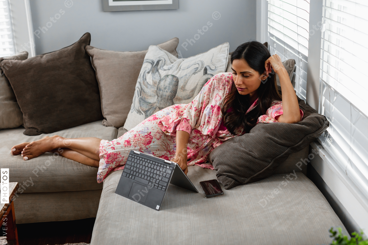 Professional Indian woman works remotely from home in comfortable house clothes