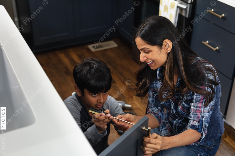Indian mother teaches son how to repair kitchen cabinets, DIY home improvement