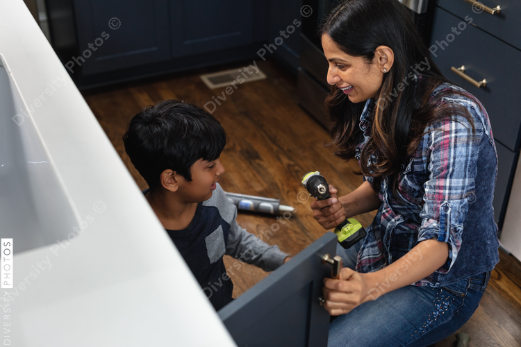 Indian mother teaches son how to repair kitchen cabinets, DIY home improvement