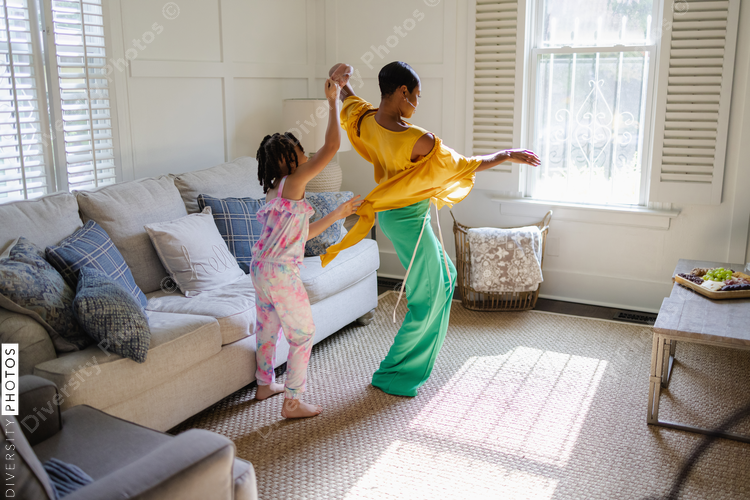 Mother and daughter learning to dance at home