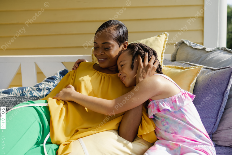 Mother and daughter relaxing on porch