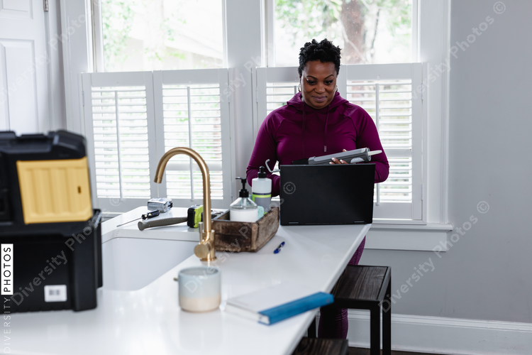 Black woman watching online tutorial for home improvement, DIY