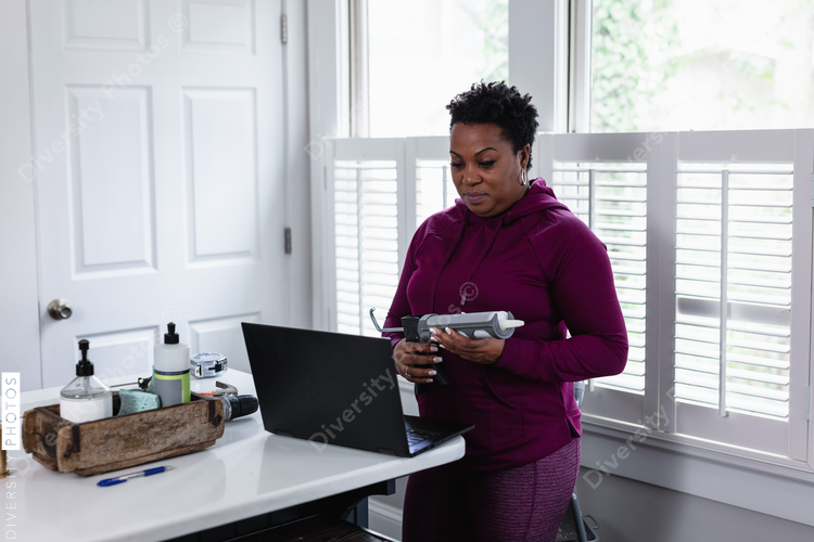 Black woman watching online tutorial for home improvement, DIY