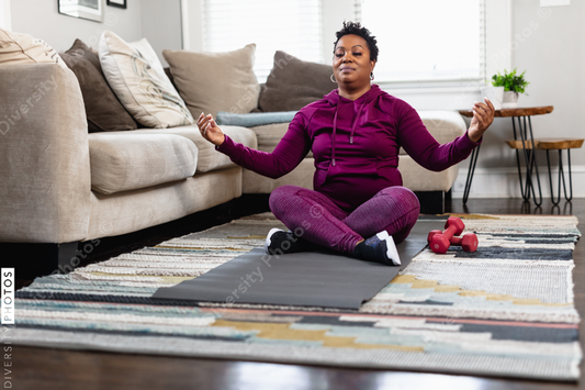 Black woman does peaceful meditation at home on floor