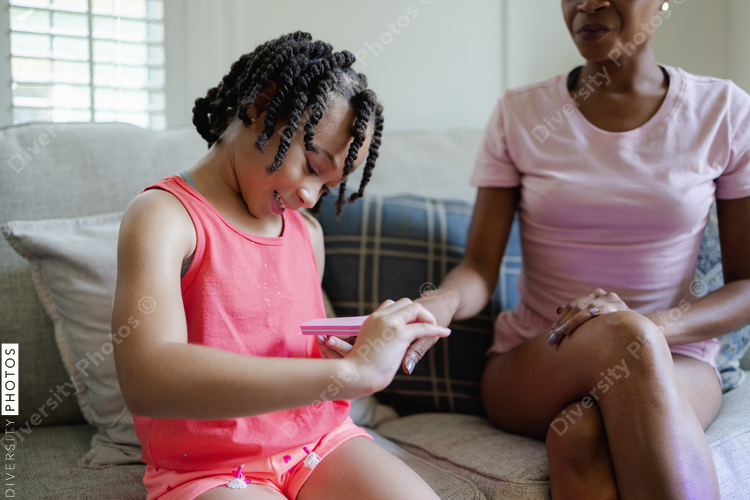 Daughter doing manicure for mother