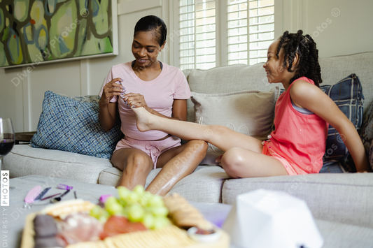 Black mom and daughter, self care at home, nail polish