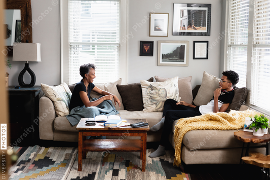 Black mother son having talk in family room, on couch, middle class home