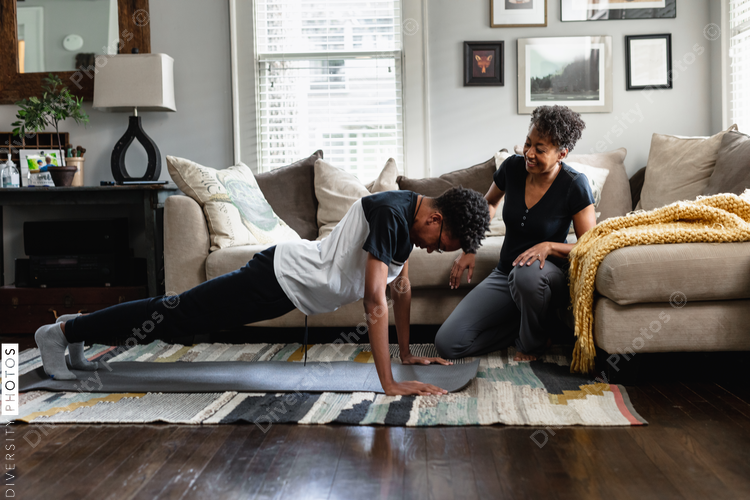 Black mom helps son do exercises at home, stay fit, health and wellness