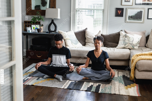Black mother and son doing meditation and breathing exercises, peaceful, relaxation