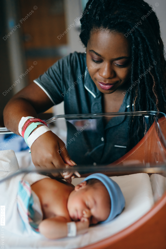Black mom checks on newborn son at hospital 
