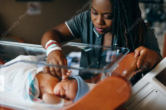 Black mom checks on newborn son at hospital 