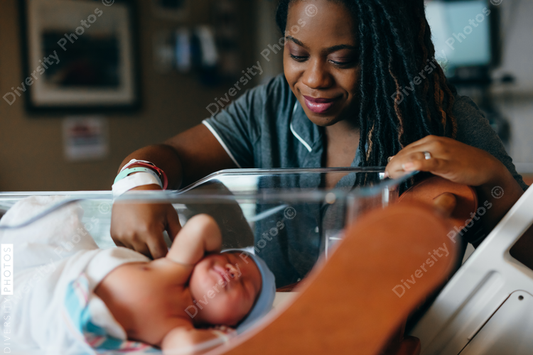 Black mom checks on newborn son at hospital 